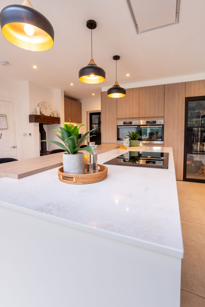 Modern light grey German handleless kitchen with peninsula layout in Pennington Hampshire