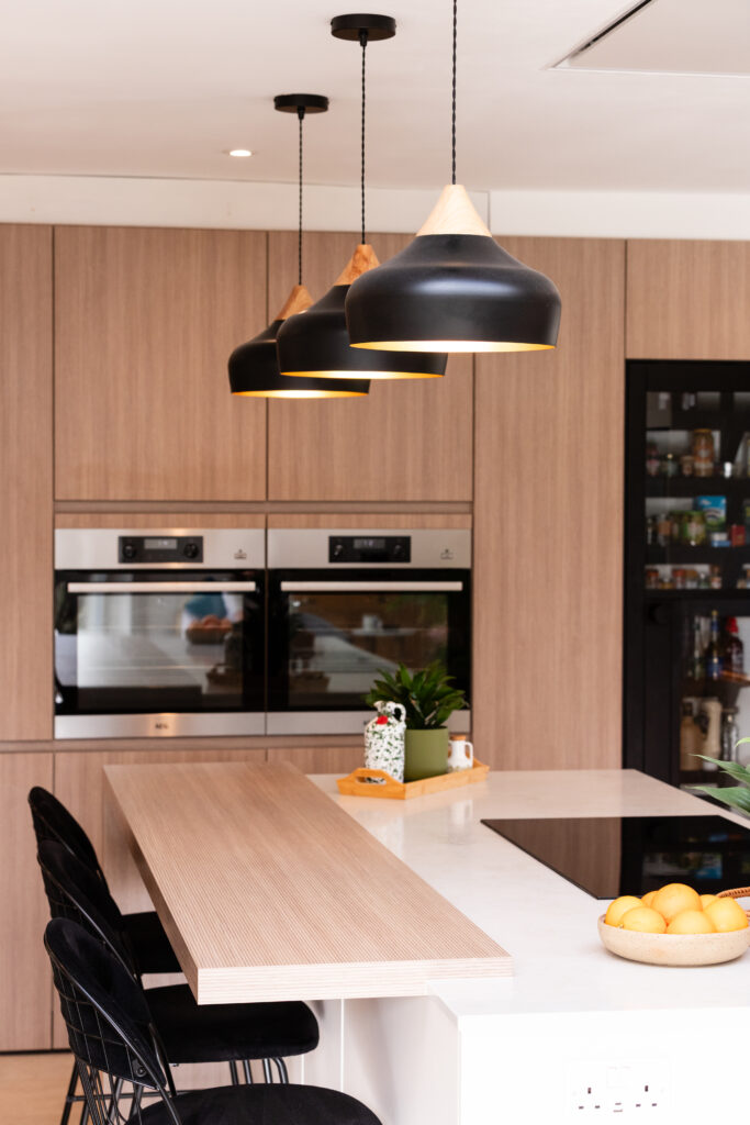 Bespoke ceiling detail with integrated Novy ceiling extractor above peninsula