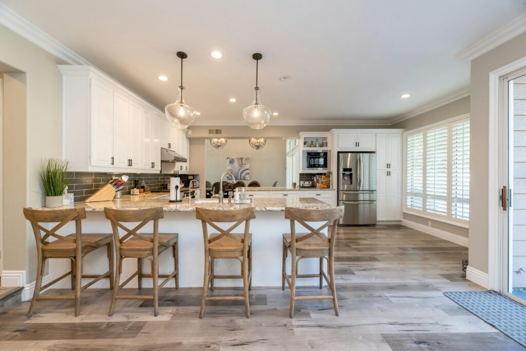 Modern open plan kitchen with breakfast bar seating, white cabinetry and spacious layout for family living
